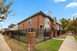 a brick house with a wrought iron fence at Montrose Walk To 50 Restaurants 1 Mile 2 DT in Houston