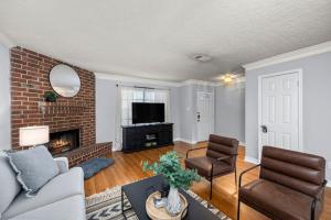 a living room with a couch and a fireplace at Montrose 2-Unit Retreat 4BR Sleeps 20 Near DT in Houston