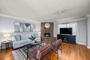 a living room with a couch and a fireplace at Montrose 2-Unit Retreat 4BR Sleeps 20 Near DT in Houston