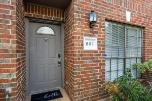 a brick building with a door with a sign on it at Montrose 2-Unit Retreat 4BR Sleeps 20 Near DT in Houston