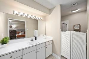 a bathroom with a sink and a mirror at Montrose 2-Unit Retreat 4BR Sleeps 20 Near DT in Houston