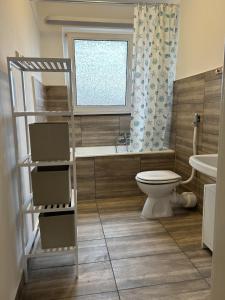 a bathroom with a toilet and a sink at Central Service Apartment in Recklinghausen