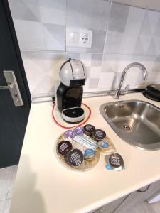 a coffee maker sitting on a counter next to a sink at Sea View Apartments Nikos in Nea Peramos