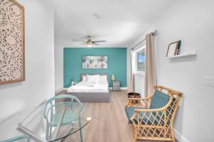 a bedroom with a bed and a glass table at Blue Wave Bungalow - 1 1 - Stylish in Dania Beach