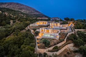 an aerial view of a home in the hills at night at Elianes Villas in Anomeriá