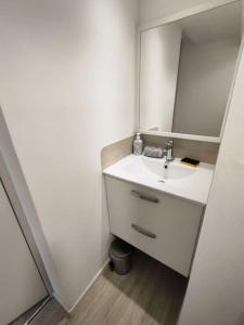 a white bathroom with a sink and a mirror at Grand volume calme centre-ville Tan1 in Cambrai