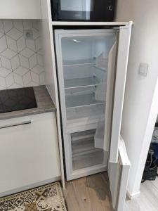 a refrigerator with its door open in a kitchen at Grand volume calme centre-ville Tan1 in Cambrai