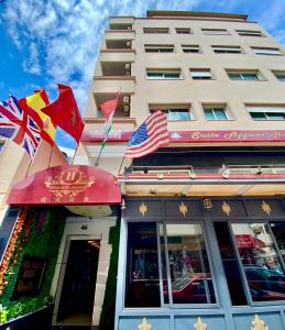 a building with flags in front of a store at Appart Hôtel Oleandro in Casablanca