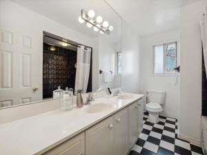 a white bathroom with a sink and a toilet at Harmony Room Creative Living in Toronto in Toronto