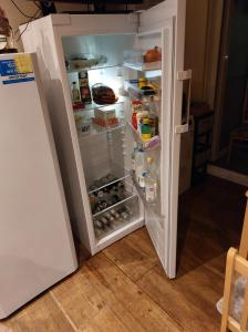 an open refrigerator with its door open and food inside at 38 Westerham in London