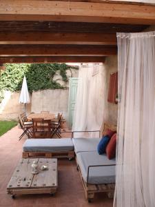 a porch with two beds and a table at El Sol del Membrillo in Corera