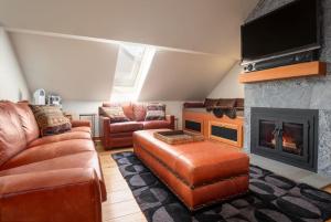 a living room with a couch and a fireplace at The Ikon Lofted Studio with King Bed and Patio in Whistler