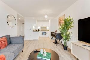 a living room with a couch and a table at CannyCity in London