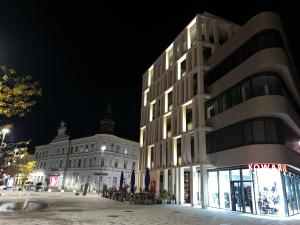 a building on a city street at night at Luxury Apartment Villach City in Villach