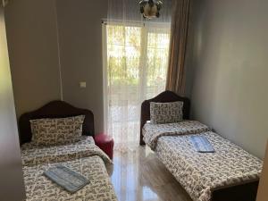 a room with two beds and a window at Hotel Toma in Khulo