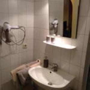 a bathroom with a sink and a mirror at Appartement Haus Anja in Bad Füssing