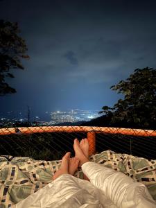 a person laying on a bed with their feet on it at Senderos Glamping in Villavicencio