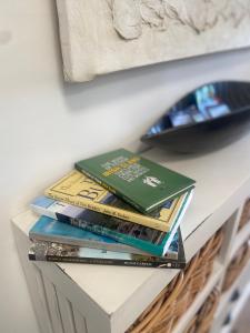 a stack of books sitting on top of a table at Oranuisce Thatch Cottage Ballyvaughan in Ballyvaughan
