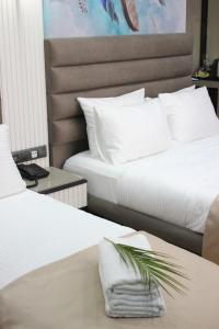 two beds sitting next to each other in a room at Dem Premium Hotel - Round Trip Airport Service - Istanbul International Airport in Arnavutköy