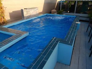 a swimming pool with a stair in the water at Villahouse3 in Vega Baja