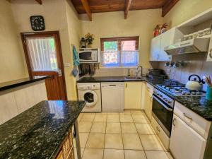 a kitchen with a stove and a dishwasher at San Lameer 2604 by Top Destinations Rentals in Southbroom