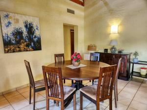 a dining room with a wooden table and chairs at San Lameer 2604 by Top Destinations Rentals in Southbroom