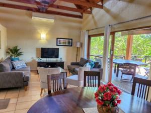 a living room with a couch and a table at San Lameer 2604 by Top Destinations Rentals in Southbroom