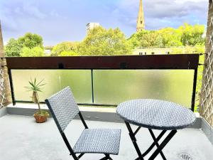 a patio with a table and two chairs on a balcony at Paddington 3 Bedroom Apartment in London