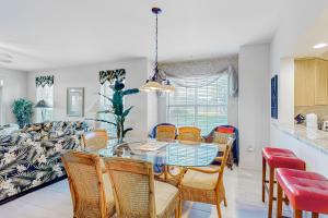 a dining room with a table and chairs and a couch at Atlantis Bliss Haven in Saint Augustine Beach