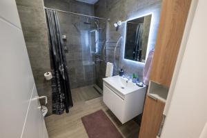 a bathroom with a sink and a shower at Apartment Nebo in Ðurđevac +13 photos