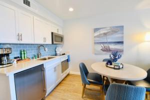 a kitchen with a table and a small table with chairs at Premium Villa - Ocean View - SEASCAPE - Heated Pools - Relaxing Fireplace - Ground Level in Aptos