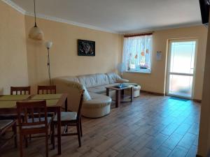 a living room with a couch and a table at Verano in Osieki