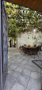 a patio with a table and chairs on a patio at 7 Rooms in Tbilisi City