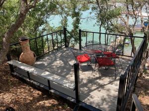 a deck with a table and chairs and a vase at Lobo Lake Cabin in Cisco