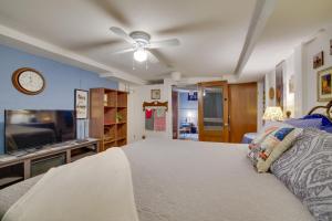 a bedroom with a bed and a ceiling fan at Harmony Home with Fire Pit 5 Mi to Niagara Cave! 