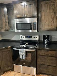 a kitchen with a stove and a microwave at Lobo Lake Cabin in Cisco