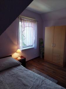 a bedroom with a bed and a window at Verano in Osieki