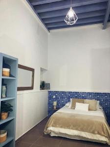 a bedroom with a bed and a blue and white wall at Loft del Capataz in San Fernando