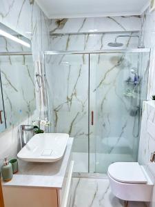 a bathroom with a shower and a sink and a toilet at Lisbon Luxury Studio in Amadora