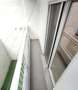 a staircase in a building with a large window at Sea View Apartments Nikos in Nea Peramos