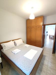 a bedroom with a bed with two napkins on it at Sea View Apartments Nikos in Nea Peramos
