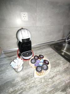 a coffee maker sitting on a counter next to a sink at Sea View Apartments Nikos in Nea Peramos +22 photos