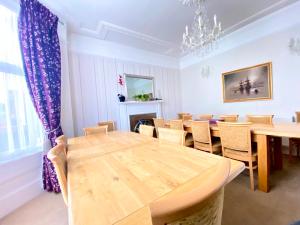 a dining room with a wooden table and chairs at Stoke villas in Gosport