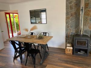 a dining room with a table and a wood stove at Viewcasavieja in Pelluhue