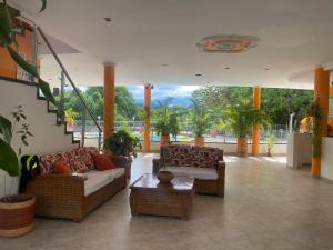 a living room with two couches and a table at Hotel la cascada cristalina in Melgar