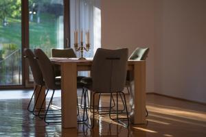 a dining room table with chairs and candles on it at CASA SPERANTA in Cugir
