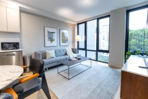 a living room with a couch and a table at 149-301 New Construcion 1BR Prime BK WD in unit in Brooklyn