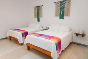 Postel nebo postele na pokoji v ubytování Linda Vecindad Playa del Carmen