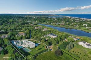 an aerial view of a large estate with a lake at Exquisite Hamptons Mansion Retreat in Water Mill