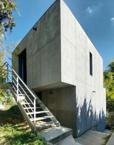 a concrete house with a staircase in front of it at La Villa Joséphine in Écully